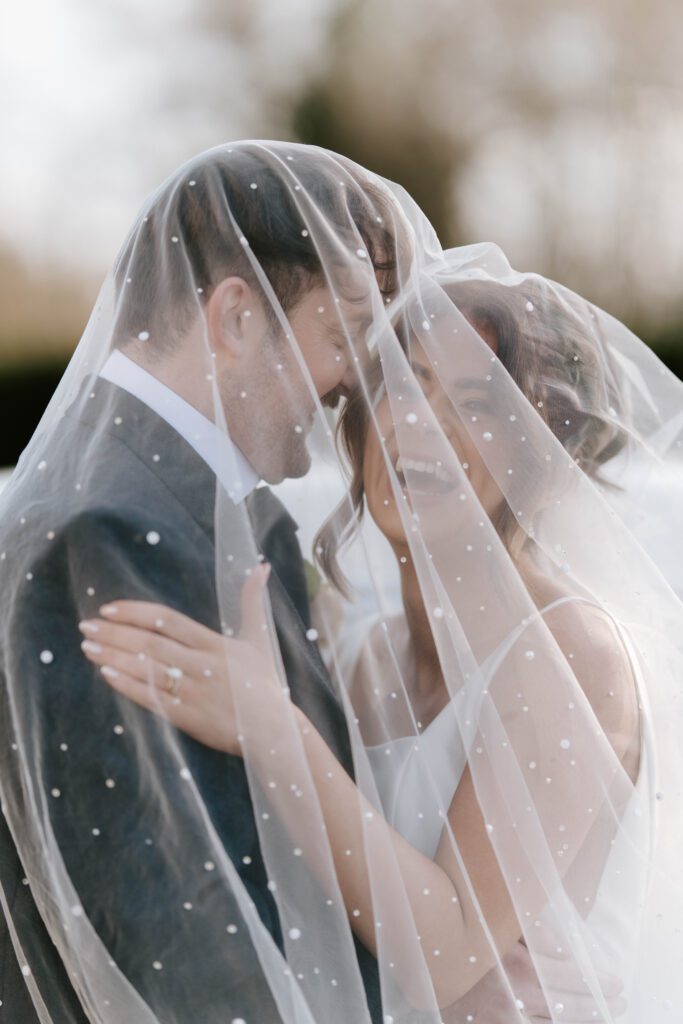 luxury wedding photography at Balbirnie House bride and groom walking elegant with vintage car
