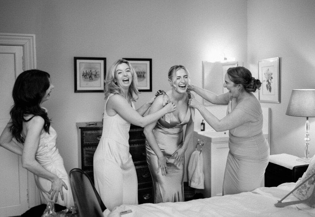 Luxury editorial wedding photography showing bridal party laughing