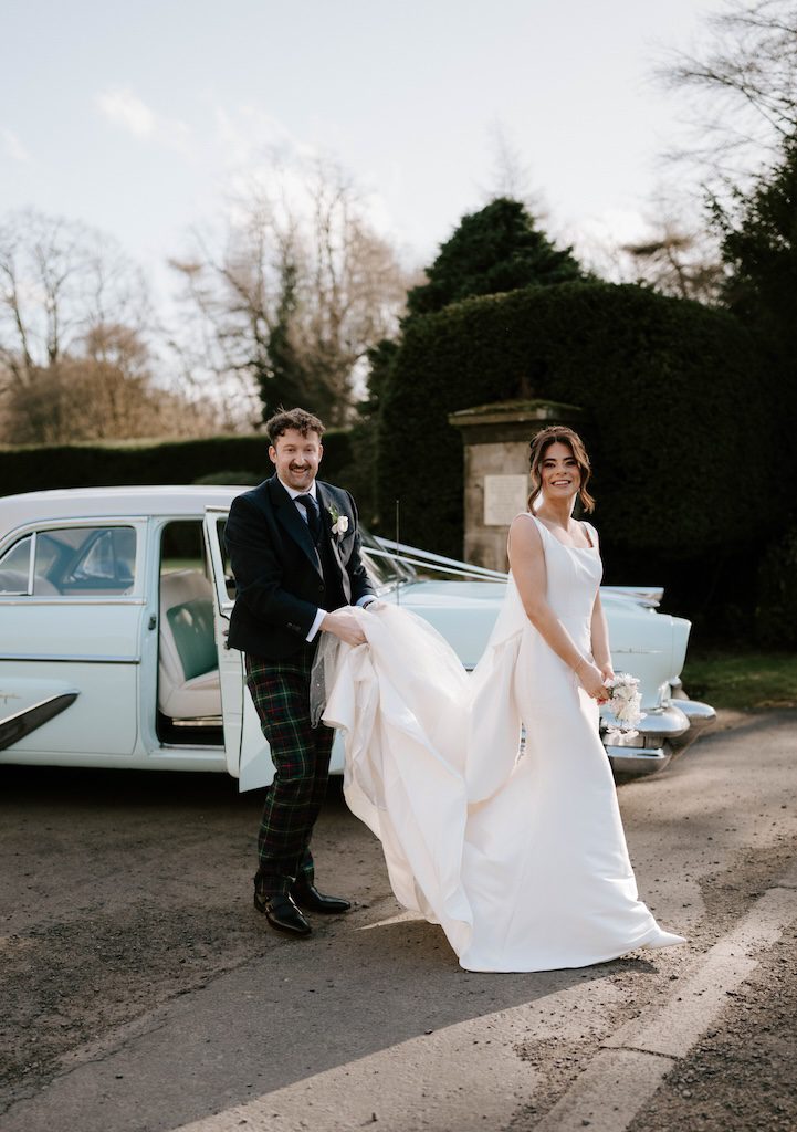 Luxury wedding photography Scotland bride and groom portrait with vintage car